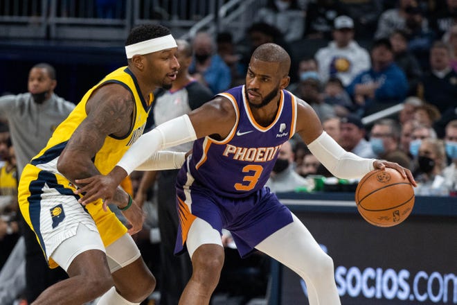 Jan 14, 2022; Indianapolis, Indiana, USA; Phoenix Suns guard Chris Paul (3) dribbles the ball while Indiana Pacers forward Torrey Craig (13) defends in the first half at Gainbridge Fieldhouse.