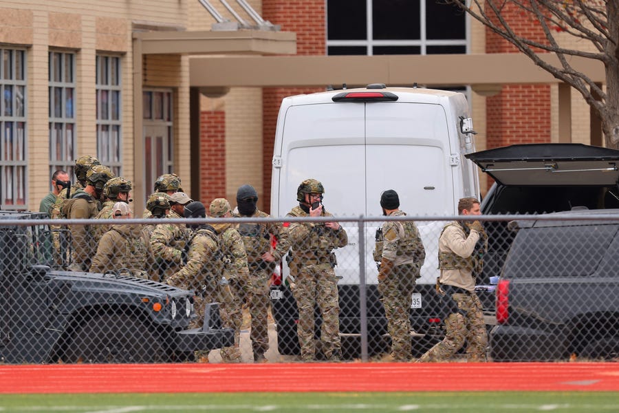 SWAT team members deploy near the Congregation Beth Israel Synagogue in Colleyville, Texas, some 25 miles (40 kilometers) west of Dallas, on January 15, 2022.