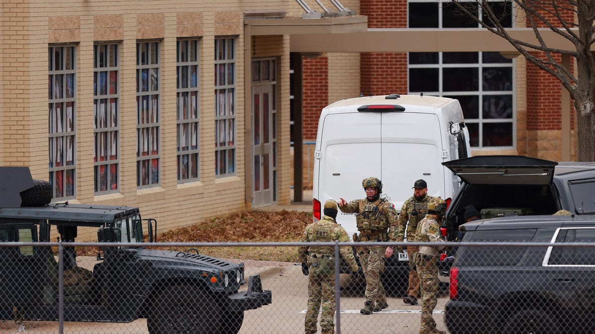 January 15, 2022: SWAT team members deploy near the Congregation Beth Israel Synagogue in Colleyville, Texas, some 25 miles west of Dallas.