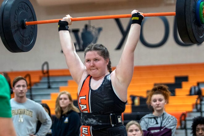 Lake Wales senior Lexi Thomas completes the clean-and-jerk en route to winning the 199-pound division on Saturday at the 2022 Polk County Girls Weightlifting Meet at Lake Wales High School.