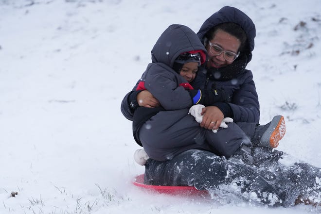 Luka Lalanne, left, sleds down a hill with his mother, Alyssa, at Scioto Audubon Metro Park after an overnight snowstorm in this January file photo.