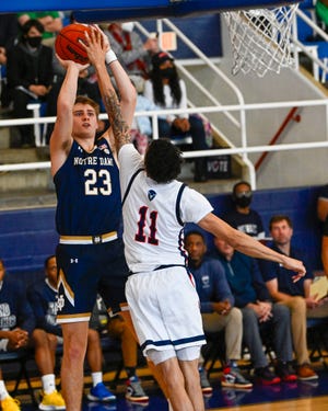 Jan 17, 2022; Washington, District of Columbia, USA; Notre Dame Fighting Irish guard Dane Goodwin (23) shoots over Howard Bison guard Kyle Foster (11) during the first half at Burr Gymnasium. Mandatory Credit: Brad Mills-USA TODAY Sports