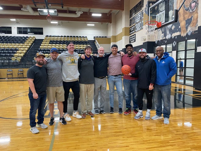 Members of the 2002-03 Cooper boys basketball team pose for a photo after the Merkel vs. Clyde game on Friday. Pictured (from left) are Taylor Lamar, Rob Galusha, Zach Jones, B.C. Lee, Marc Case, Kai Johnson, Chris Gammage, Josh Benningfield and James Peters.