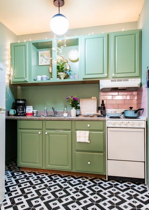 A studio apartment kitchen McMahan and her business partner renovated in their Old Louisville apartment building. McMahan took inspiration for the color palette from a Wes Anderson-designed cafe in Milan.