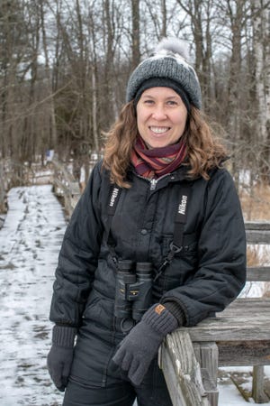 Rebecca Jabs, a Manitowoc artist and graphic designer who collaborated with author and naturalist John Bates on a guidebook called "Wisconsin's Wild Lakes", poses on a trail along the Woodland Dunes area in Manitowoc.