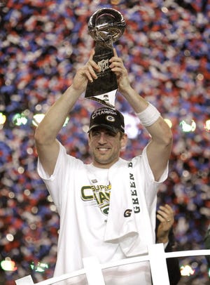 Aaron Rodgers celebrates the Super Bowl XLV championship by holding the Lombardi Trophy after leading the Packers to a 31-26 victory over the Pittsburgh Steelers Feb. 6, 2011, at Cowboys Stadium in Arlington, Texas.