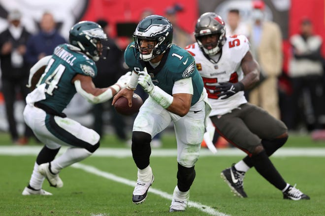 Philadelphia Eagles quarterback Jalen Hurts (1) runs with the ball against the Tampa Bay Buccaneers during the second half of an NFL wild-card football game Sunday, Jan. 16, 2022, in Tampa, Fla. (AP Photo/Mark LoMoglio)