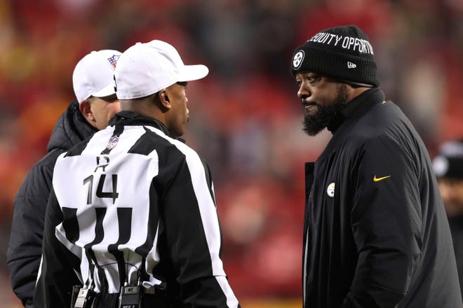 Pittsburgh Steelers head coach Mike Tomlin, right, talks with referee Shawn Smith, left, during the first half of an NFL wild-card playoff football game against the Kansas City Chiefs, Sunday, Jan. 16, 2022, in Kansas City, Mo. (AP Photo/Travis Heying)