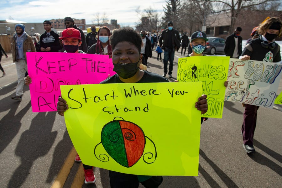 Savion Bates leads the annual Dr. Martin Luther King Jr. March from Washington Park in Fort Collins, Colo. Monday, Jan. 17, 2022.  