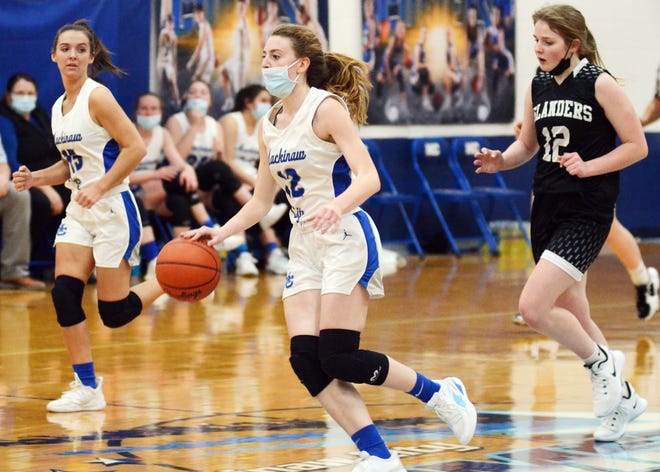 Mackinaw City's Larissa Huffman (middle) pushes the ball down the court with teammate Marlie Postula (left) flanking her and Cedarville-DeTour's Taylor Williams trailing during their non-conference matchup Monday in Mackinaw City.