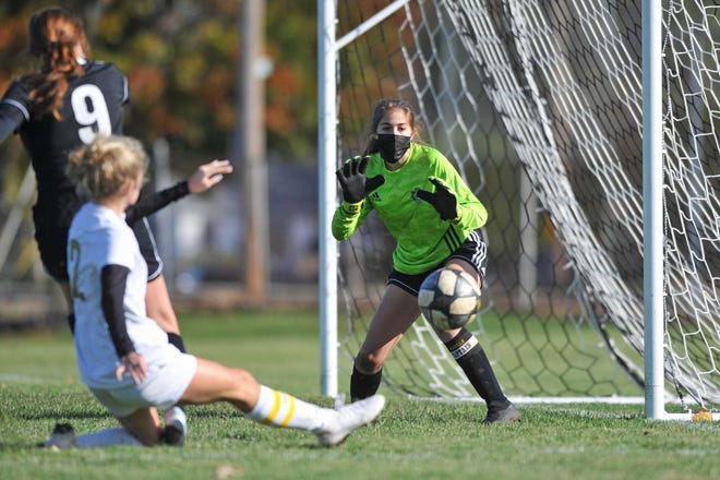 Pilgrim goalkeeper Janelle Mixner prepares for a shot by North Kingstown’s Haleigh Ward during a game last fall.
