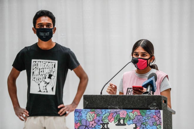 Students in bipartisan group "Confront the Climate Crisis," Rahul Durai, left, and Siya Goel, right, speak to fellow students and legislators on legislative advocacy day, Jan. 18, 2022, at the Indiana Statehouse.  