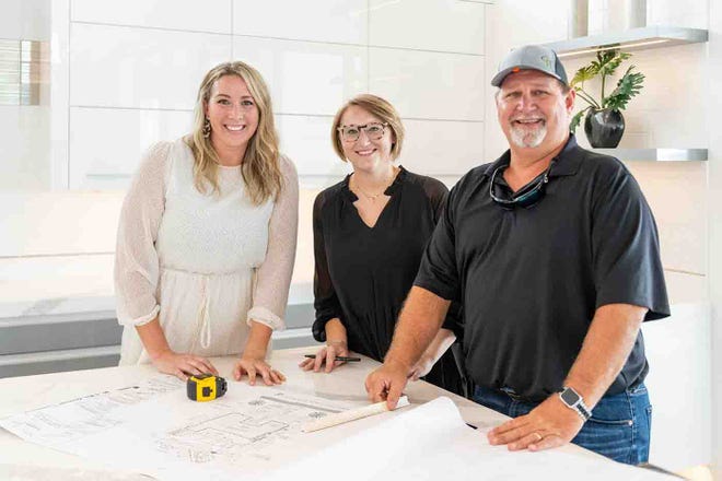 Brooke Meyer (left), Principal Interior Designer for Gulfshore Homes’ new interior design division, reviews plans with interior designer, Lindsay Molinario, and Matt Shull, Gulfshore Homes executive vice president.
