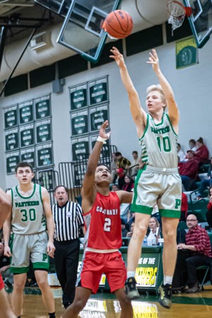 Pennfield's Aiden Burns fires a jumper over Coldwater's Lu Lebron during first half action at Pennfield High School on January 18, 2022.