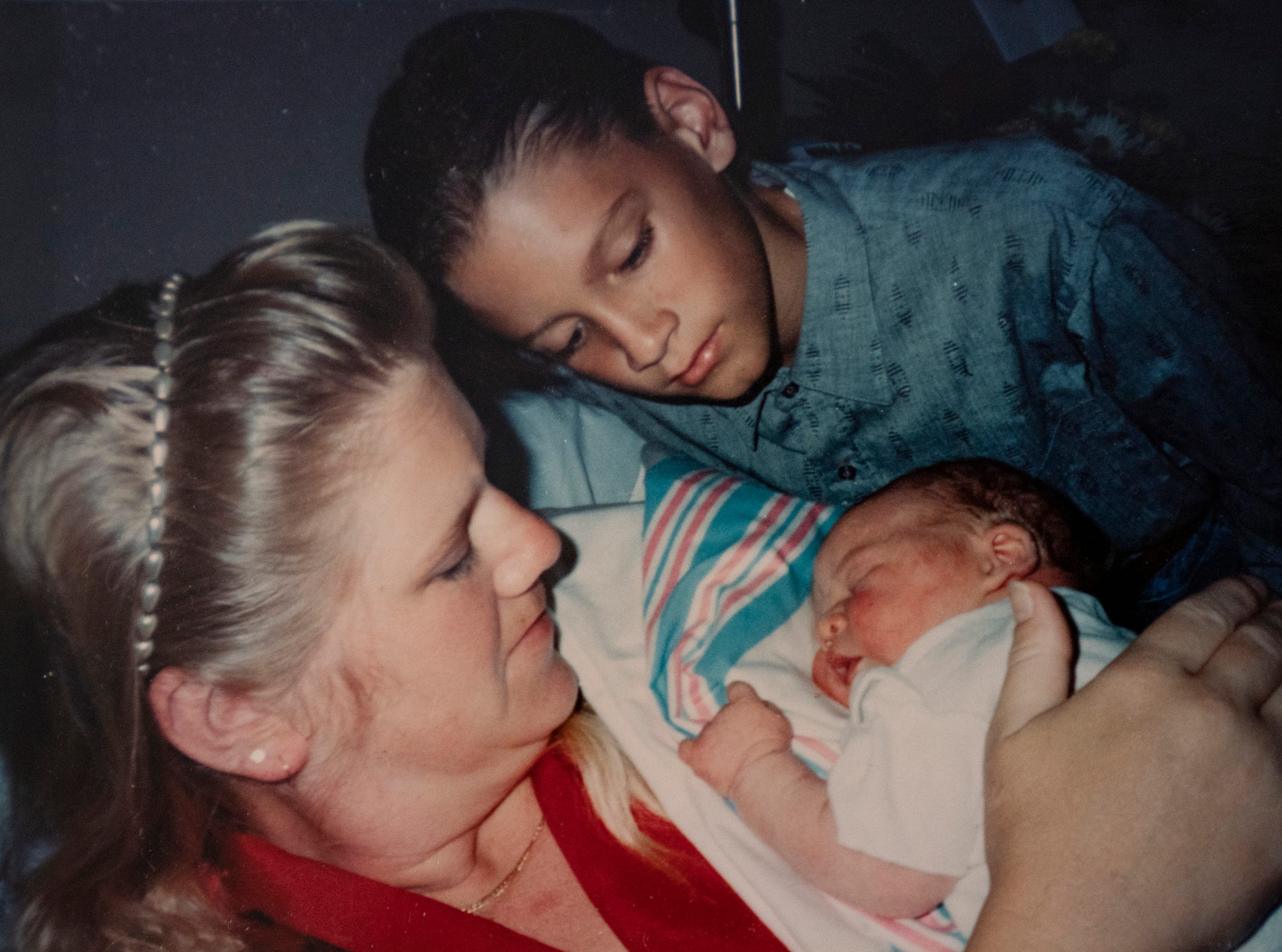 Kathi Kuykendall keeps this sentimental photo of her with baby Asa taken in 1993, when he was just a day old, and older son Eric Kuykendall looks on at right. They lived in Florida at the time. She keeps the photo at her home in Allen Park Wednesday, Nov. 3, 2021.
