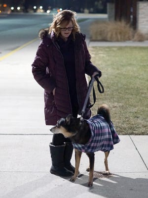 Karissa Parran walks her dog Bella at Westland's Tatan Park on Jan. 18, 2022.