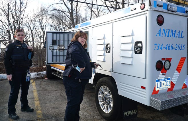                                Livonia Animal Control officers Officers Keri Brandon, left, and Shellean Polovich open up one of their two trucks used to pick up dogs, cats and other stray animals 