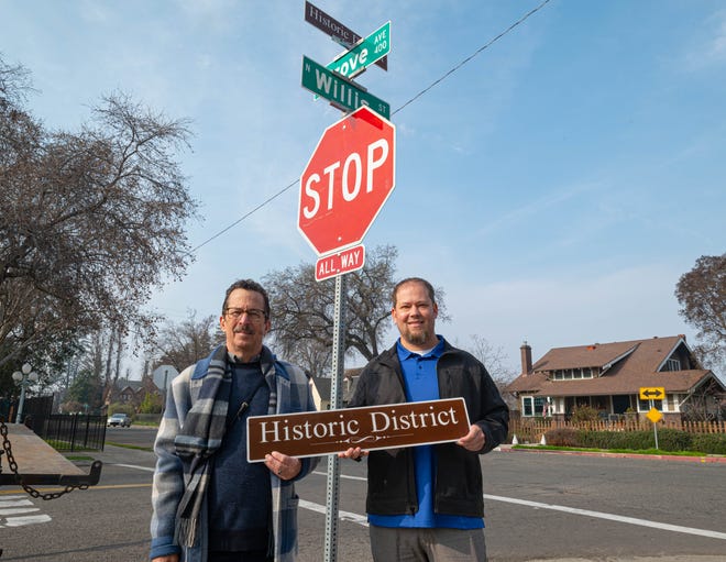 Visalia Councilman Brett Taylor, pictured right, and Walter Deissler, Visalia Historic Preservation Advisory Committee chairman, pose in front of new signs advertising the city's historic district.