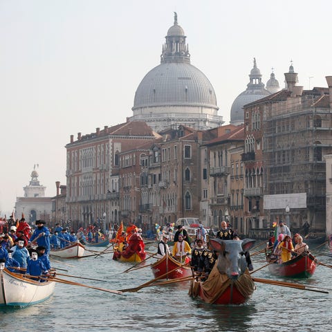 Boats sail during the water parade, part of the Ve