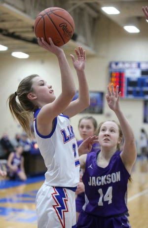 Emma Anderson (left) of Lake takes a shot while being guarded by Cassie McMurtry (right) of Jackson during their game at Lake on Wednesday.