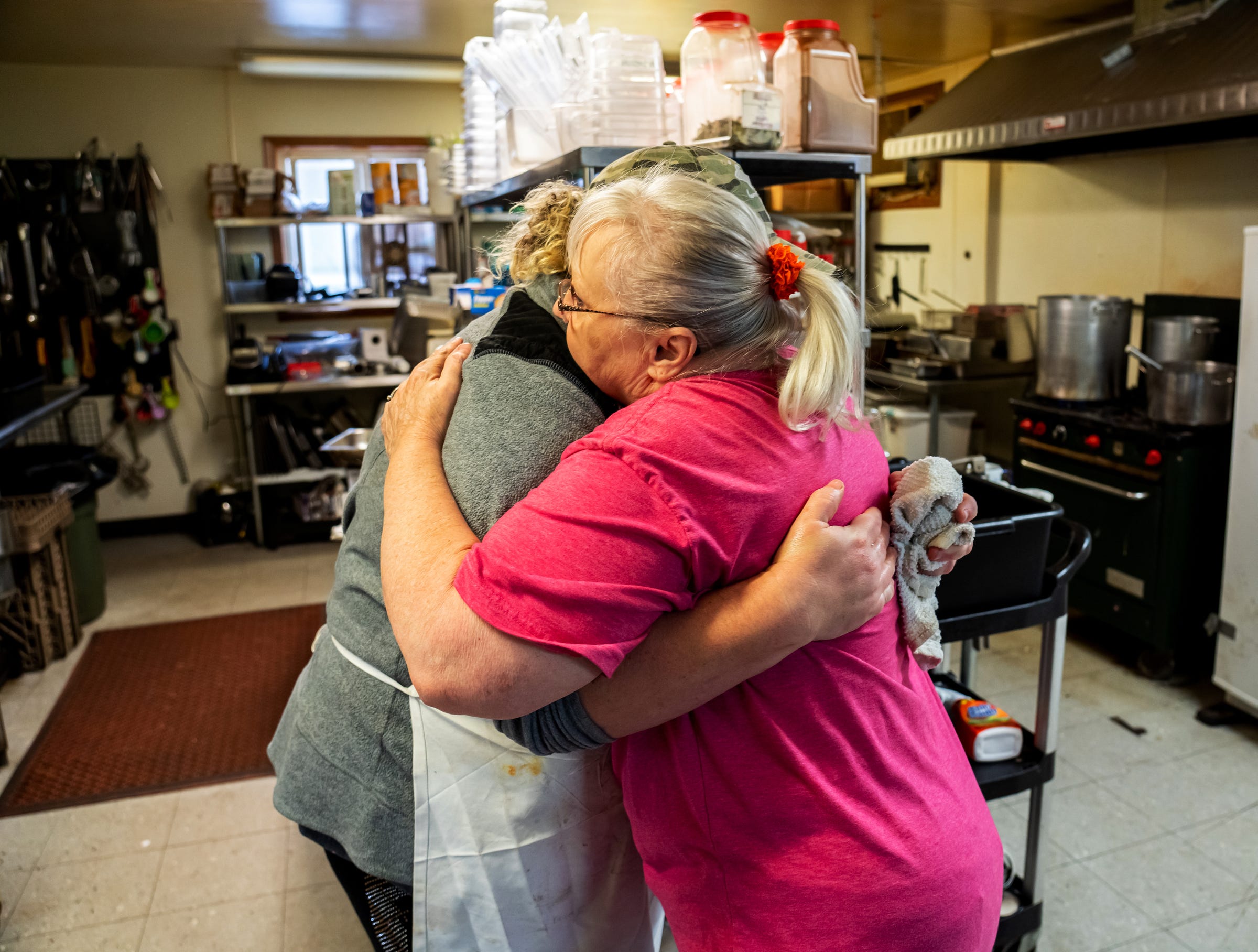 Jan Wehmeyer, right, of Gwinn, gives a hug to Shannon's Home Cooking owner Shannon Greathouse on Wednesday, Oct. 20, 2021, as Greathouse deals with a tough, long day. Wehmeyer was once a dishwasher at the restaurant.