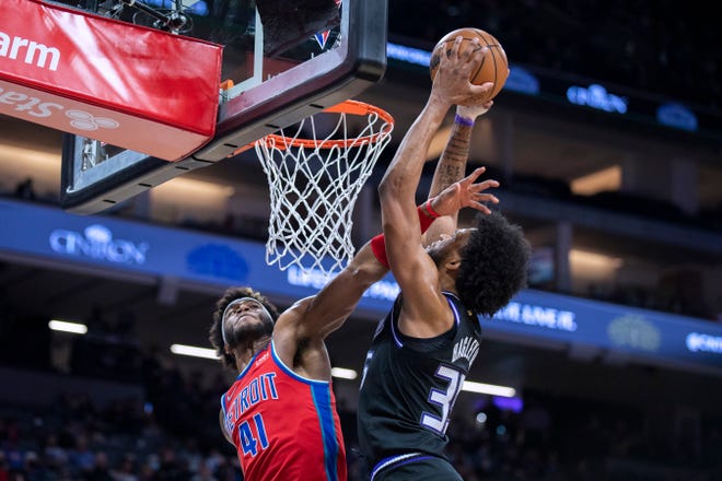 Kings forward Marvin Bagley III scores and is fouled by Pistons forward Saddiq Bey during the second half in Sacramento, Jan.  19, 2022.