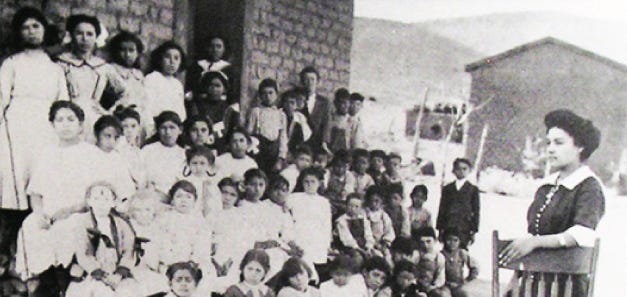 Miss Fortunata Guerrero, first Hispanic graduate in 1911 from Normal School (Teachers College) in Silver City. Guerrero is photographed with her students from San Juan Public School in Mimbres