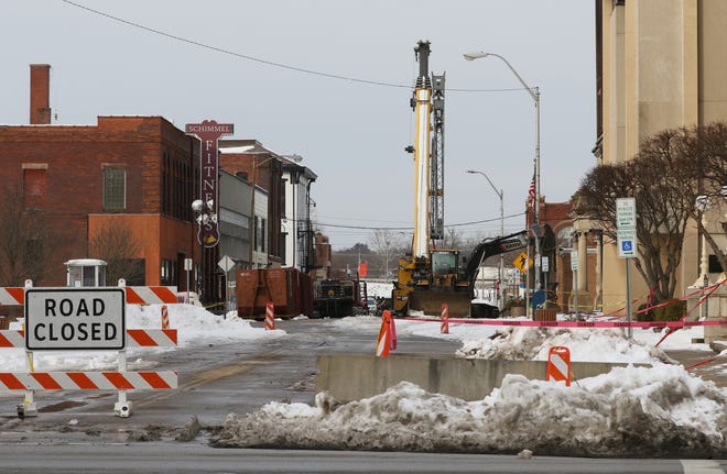 A crane and other heavy equipment stands on Fourth Street in Zanesville on Wednesday, in preparation for the demolition of the Masonic Temple.