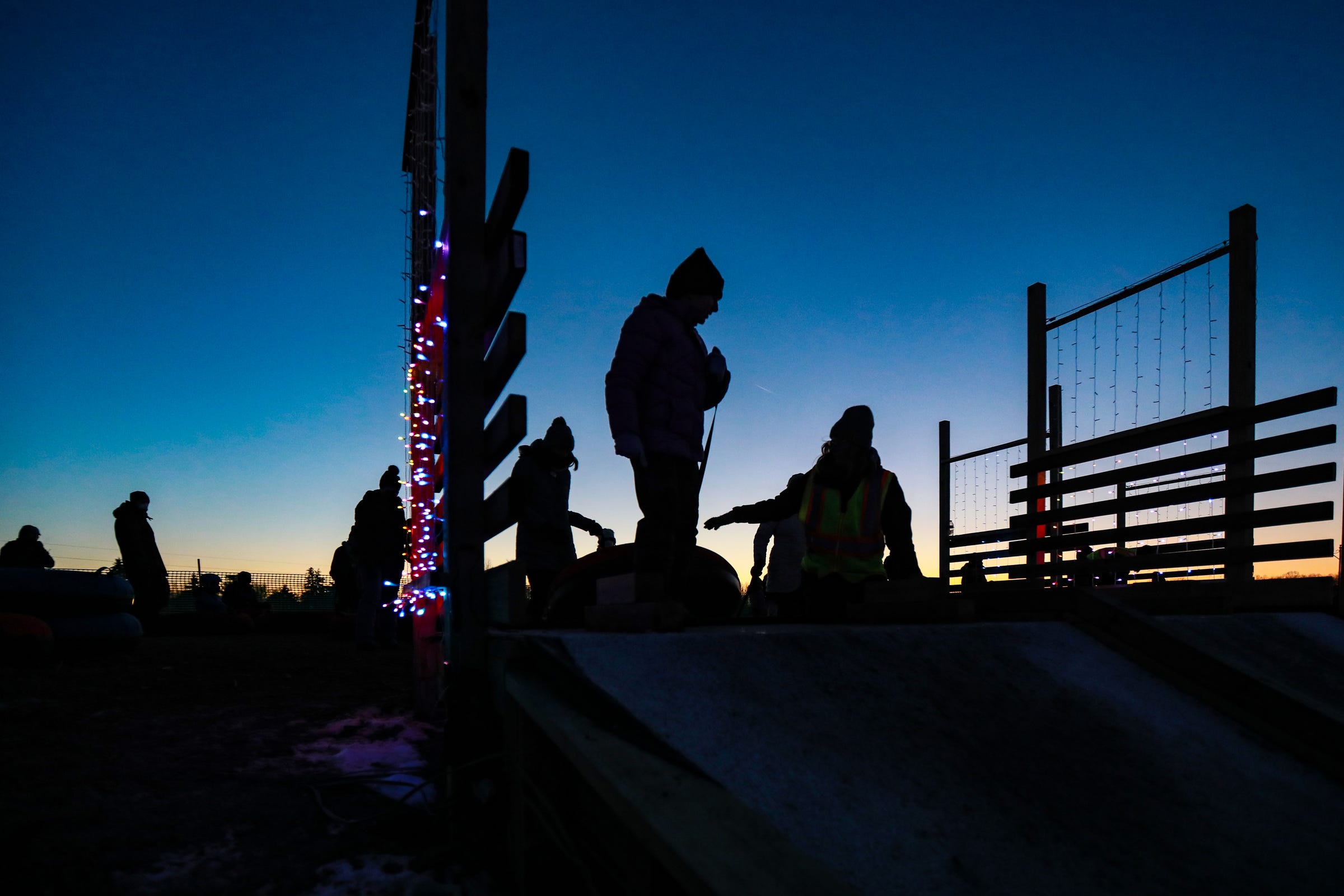 Sledding lanes at Bowers School Farm Winter Park are decorated with blinking lights and feature a snow carpet used in the south to combat the lack of snow to smooth out surface tension. Park-goers braved the frigid temperatures that reached 5 degrees Jan. 15, 2022, to rocket down the hill, spinning and laughing on the way down. Alan Jaros, the director of the farm, says last year's hay bales were transformed into four sledding lanes in just 30 days.