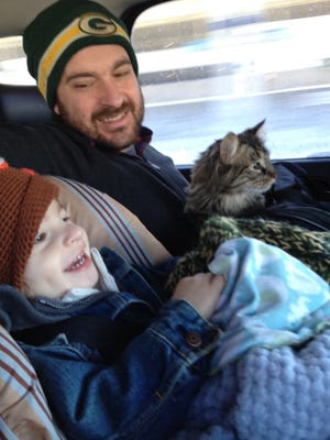 Patrick Somerville rides with his son, Leo, and cat, Jack. Somerville, the showrunner for HBO hit "Station Eleven," has a longtime family connection to the Green Bay Packers.