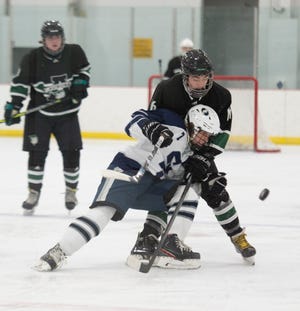 Aurora ice hockey takes on the Solon Comets at Gilmour Academy on Friday, January 21. Conor McMahon battles with Zachary Nathanson.