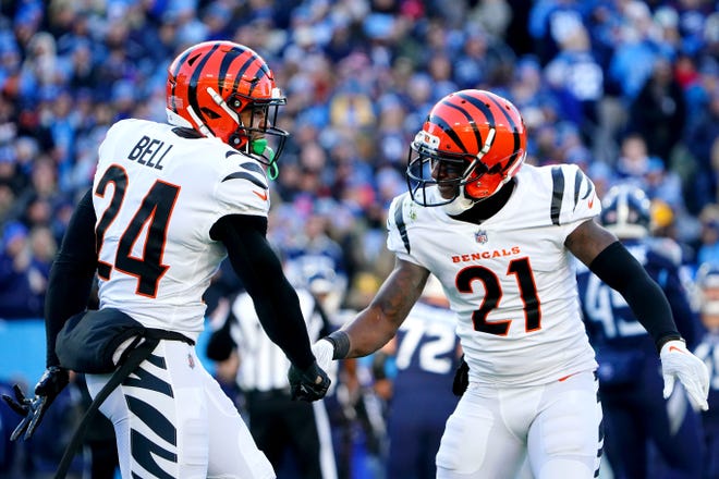 Cincinnati Bengals safety Vonn Bell (24) and Cincinnati Bengals cornerback Mike Hilton (21) celebrate a sack of Tennessee Titans quarterback Ryan Tannehill (17) (not pictured) in the first quarter during an NFL divisional playoff football game, Saturday, Jan. 22, 2022, at Nissan Stadium in Nashville.