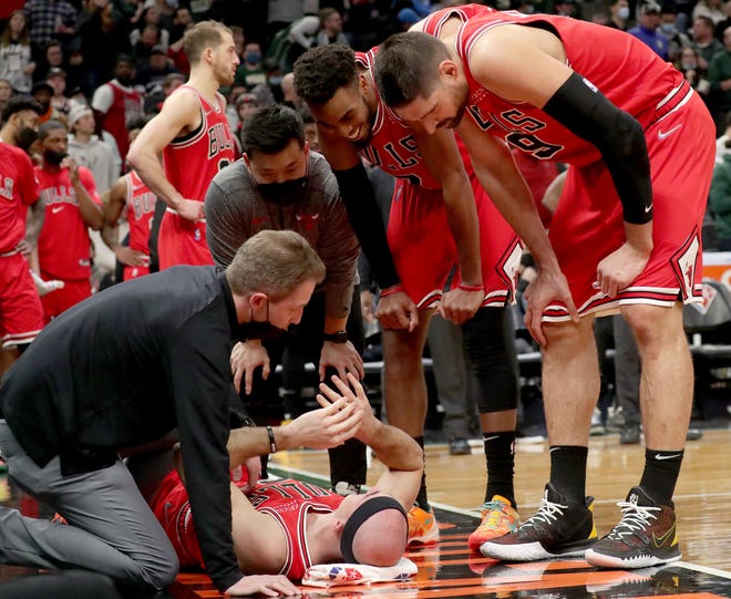 Bulls guard Alex Caruso lies on the floor after being found by Bucks guard Grayson Allen during the third quarter Friday night at Fiserv Forum.