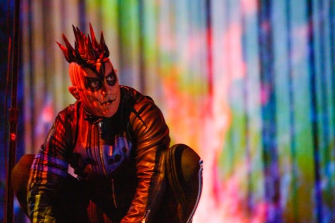 Maynard James Keenan, frontman of metal band, Tool, stays at the back of the stage, on a stage, as he performs at the Imprint Center in Phoenix, Arizona