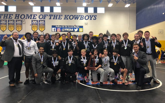 The Jensen High School wrestling team and coaches pose after winning the FHSAA State Dual Championships Saturday in Kissimmee.