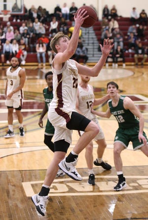 Garrison Keeslar, 21, of Walsh goes to the basket during Saturday's game against Lake Erie.