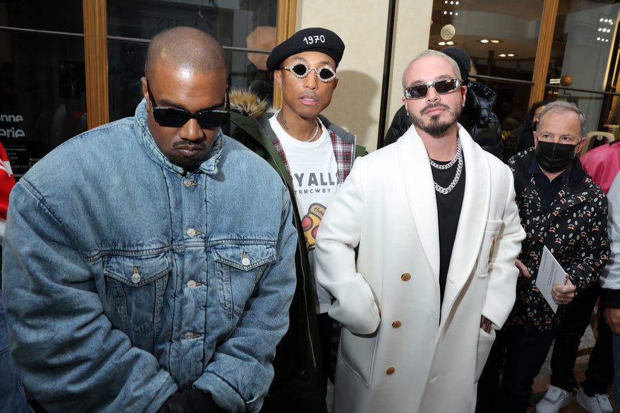 (L to R) Ye, Pharrell Williams and J Balvin attend the Kenzo Fall/Winter 2022/2023 show as part of Paris Fashion Week on January 23, 2022 in Paris, France.