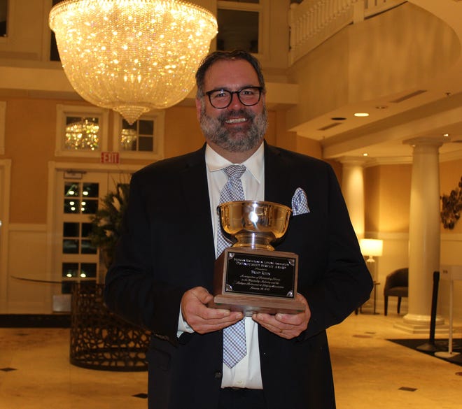 Brad Keen of Boyne Resorts accepts the Distinguished Service award at the recent Michigan Restaurant and Lodging Association awards ceremony.