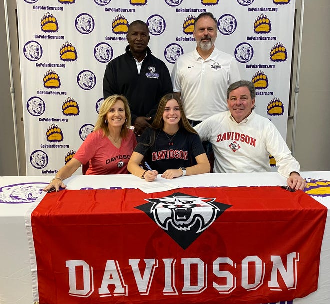 Jackson High School's Allie Hartnett is joined by her parents Chryssa and Tom and Polar Bears coaches Mike Peterson and John Kroah as she signs her letter of intent to play college lacrosse at Davidson.