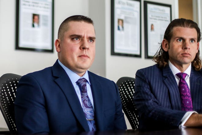 Michigan State Police Trooper Mark Andrews, 32, left, recalls his experience as a state trooper during a meeting with Attorney Jonathan Marko, right, and Attorney Cait Malhiot at Marko Law Firm in Detroit on Thursday, Jan. 20, 2022. Andrews raised concerns with supervisors after he found out about fellow troopers drinking alcohol on duty – and violating state COVID-19 guidelines – at an August 2020 house party. Andrews is now suing, alleging retaliation and other civil infractions.