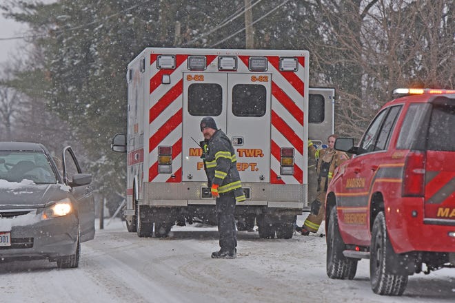 Madison Township fire chief Ken Justus carried a woman from a house fire at 1092 Fifth Avenue on Monday afternoon.