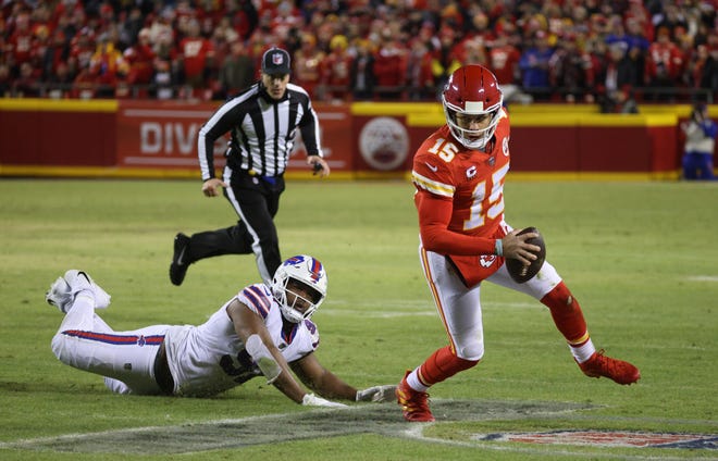 Chief quarterback Patrick Mahomes slides the tackle of Bills Ed Oliver.