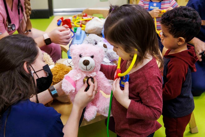 Sarah Hicks, a second-year medical student at the FSU College of Medicine from St. Cloud, demonstrates how a stethoscope checks a patient’s heartbeat during the Teddy Bear Clinic at FSU’s Childcare and Early Learning Program.