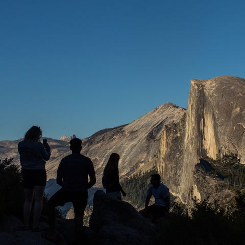 Visitors take in the view of Half Dome from Yosemi