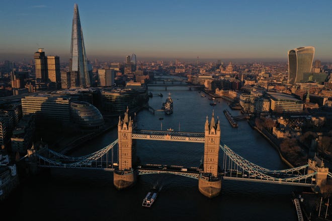 Tower Bridge, the River Thames, The Shard and St. Paul's Cathedral can be seen as the sun rises in London on Jan. 14, 2022.