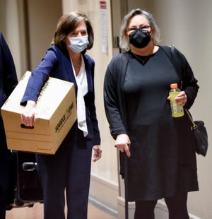 Leigh Corfman, right, who accused former Alabama Chief Justice Roy Moore of sexual assault, walks into the courtroom in the Montgomery County Courthouse in Montgomery, Ala., on Tuesday January 25, 2022, for opening arguments, as the trial for Corfman and Moore’s defamation lawsuits against each other begins.