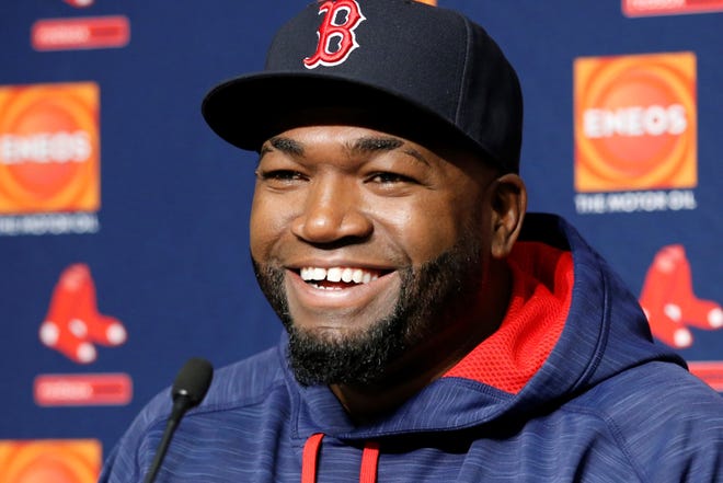 FILE - In this Sept. 27, 2016, file photo, Boston Red Sox designated hitter David Ortiz laughs during a press conference at Yankee Stadium in New York. Actor John Krasinski and the retired Red Sox slugger announced Sunday, April 12, 2020, during Krasinski's "Some Good News" YouTube show that workers at Beth Israel Deaconess Medical Center in Boston would be getting free Red Sox tickets. (AP Photo/Kathy Willens, File)