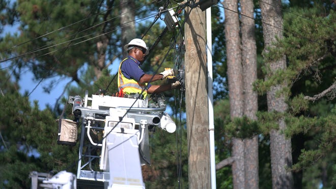 An AT&T employee works on high-speed Internet service.