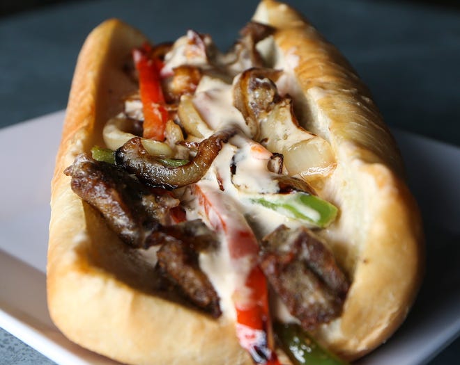 The First State Brewing Company's scrapple cheesesteak sandwich - complete with its five cheese fondue topping.
