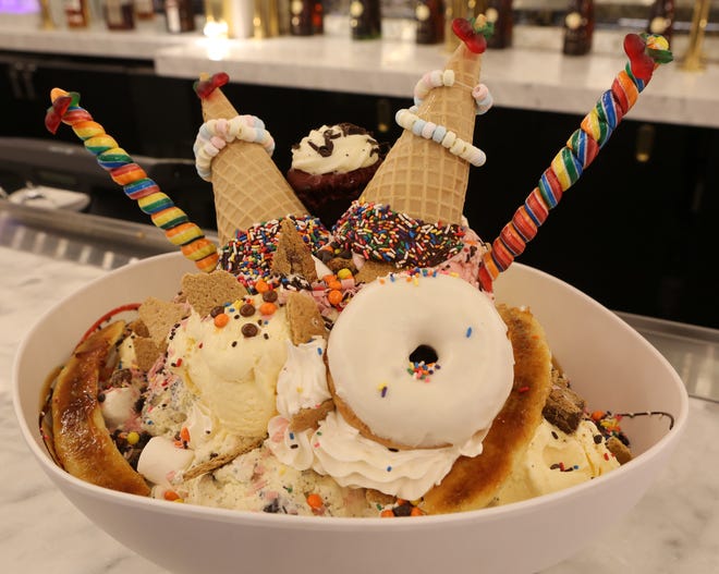 The King Kong Sundae at the Sugar Factory in Dover is made up of 24 scoops of ice cream, two waffle cones, a donut, and a cupcake among other toppings.